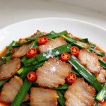A plate of Sichuan Twice-Cooked Pork with Garlic Sprouts